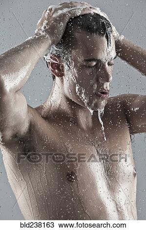 Stock Image - Caucasian man showering. Fotosearch