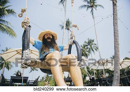 Caucasian man sitting on rope swing yelling View Large Photo Image Stock Photo - Caucasian man sitting on rope swing yelling. Fotosearch