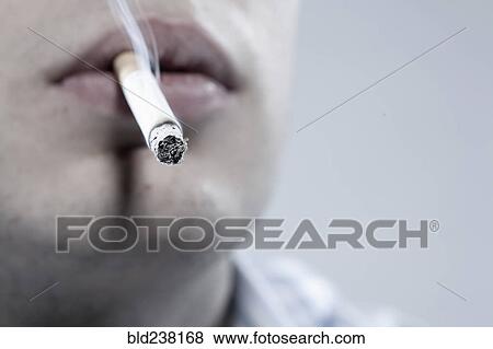 Stock Photo - Caucasian man smoking cigarette. Fotosearch