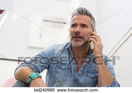 Caucasian man talking on cell phone View Large Photo Image Stock Photo - Caucasian man talking on cell phone. Fotosearch