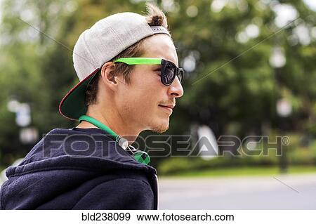 Stock Photo - Caucasian man wearing sunglasses and headphones. Fotosearch