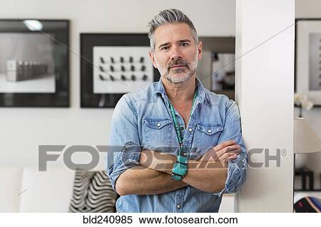 Caucasian man with arms crossed leaning on pillar View Large Photo Image Stock Photography - Caucasian man with arms crossed leaning on pillar. Fotosearch