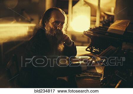 Stock Photo - Caucasian man with beard reading book. Fotosearch