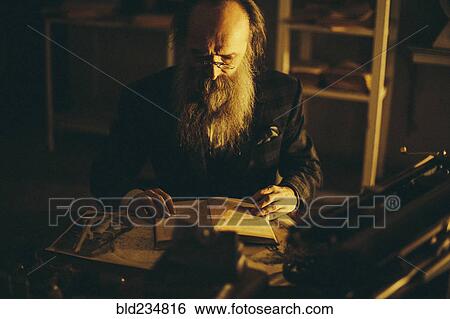 Caucasian man with beard reading book View Large Photo Image Stock Photograph - Caucasian man with beard reading book. Fotosearch