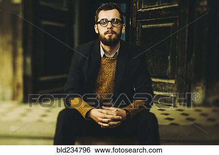 Caucasian man with beard sitting on front stoop View Large Photo Image Stock Photograph - Caucasian man with beard sitting on front stoop. Fotosearch