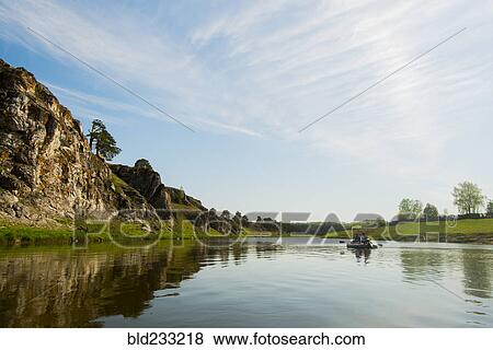 Stock Photo - Caucasian men in inflatable raft on river. Fotosearch