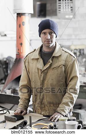 Caucasian metal worker standing in workshop View Large Photo Image Stock Photography - Caucasian metal worker standing in workshop. Fotosearch