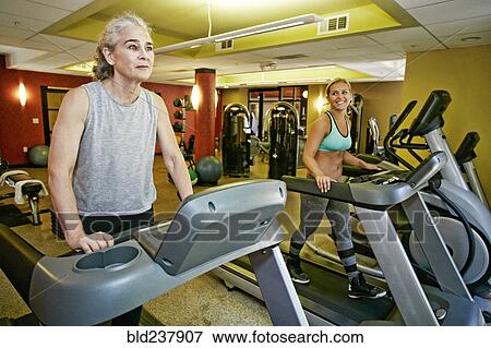 Caucasian mother and daughter on treadmills View Large Photo Image Stock Photo - Caucasian mother and daughter on treadmills. Fotosearch