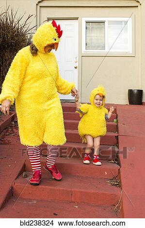 Caucasian mother and daughter wearing chicken costumes View Large Photo Image Picture - Caucasian mother and daughter wearing chicken costumes. Fotosearch