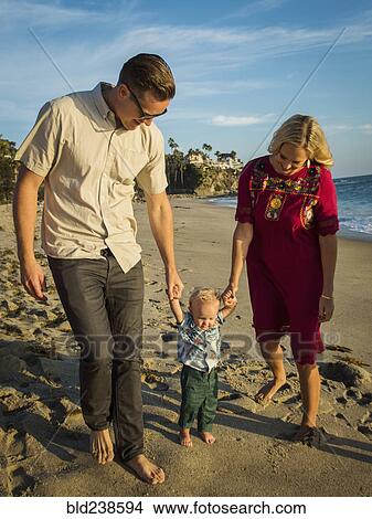 Caucasian mother and father walking baby son on beach View Large Photo Image Picture - Caucasian mother and father walking baby son on beach. Fotosearch