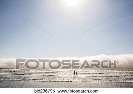Caucasian mother and son wading in ocean waves at beach View Large Photo Image Stock Photography - Caucasian mother and son wading in ocean waves at beach. Fotosearch