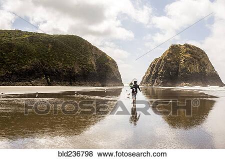 Caucasian mother carrying daughter on beach View Large Photo Image Stock Photo - Caucasian mother carrying daughter on beach. Fotosearch