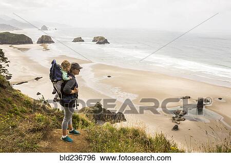 Caucasian mother carrying daughter on beach View Large Photo Image Stock Photograph - Caucasian mother carrying daughter on beach. Fotosearch
