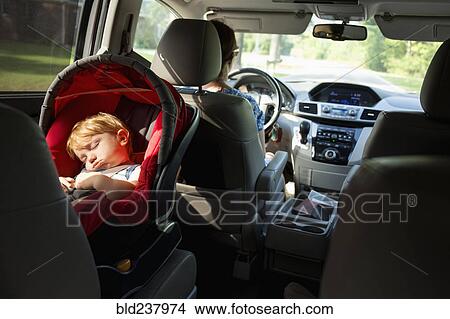 Caucasian mother driving car with baby son in car seat View Large Photo Image Picture - Caucasian mother driving car with baby son in car seat. Fotosearch