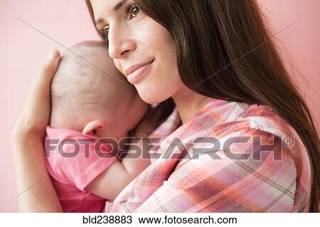Caucasian mother hugging baby daughter View Large Photo Image Stock Image - Caucasian mother hugging baby daughter. Fotosearch