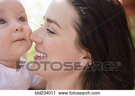 Caucasian mother rubbing nose on cheek of baby son View Large Photo Image Stock Image - Caucasian mother rubbing nose on cheek of baby son. Fotosearch