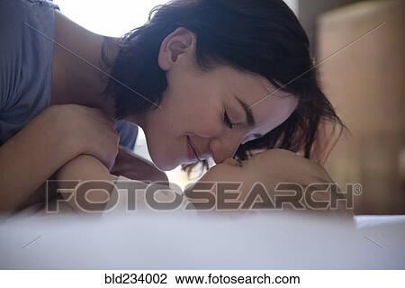 Caucasian mother rubbing noses with baby son on bed View Large Photo Image Stock Image - Caucasian mother rubbing noses with baby son on bed. Fotosearch