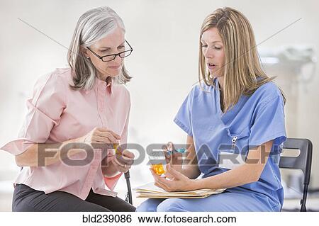 Caucasian nurse explaining prescription to patient View Large Photo Image Stock Photograph - Caucasian nurse explaining prescription to patient. Fotosearch