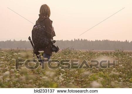 Caucasian photographer standing in field of flowers View Large Photo Image Stock Photo - Caucasian photographer standing in field of flowers. Fotosearch