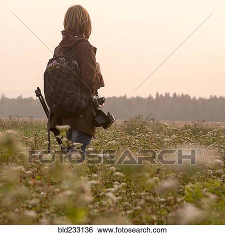 Caucasian photographer standing in field of flowers View Large Photo Image Stock Photograph - Caucasian photographer standing in field of flowers. Fotosearch