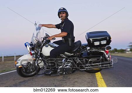 Caucasian policeman riding on motorcycle View Large Photo Image Stock Photo - Caucasian policeman riding on motorcycle. Fotosearch