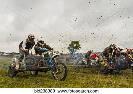 Caucasian racers on motorcycles with side cars spraying dirt View Large Photo Image Stock Photo - Caucasian racers on motorcycles with side cars spraying dirt. Fotosearch