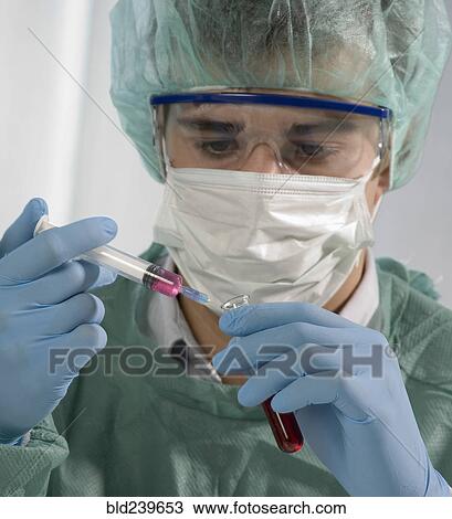 Caucasian scientist holding syringe and test tube View Large Photo Image Stock Image - Caucasian scientist holding syringe and test tube. Fotosearch