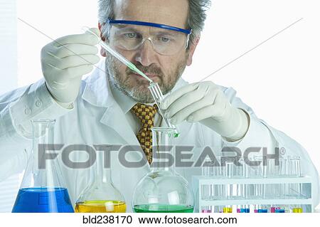 Caucasian scientist mixing liquid in laboratory View Large Photo Image Stock Image - Caucasian scientist mixing liquid in laboratory. Fotosearch