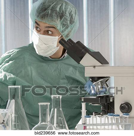 Stock Photograph - Caucasian scientist surprised in laboratory. Fotosearch