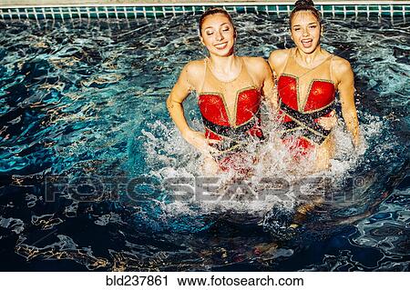 Caucasian synchronized swimmers splashing in swimming pool View Large Photo Image Stock Image - Caucasian synchronized swimmers splashing in swimming pool. Fotosearch