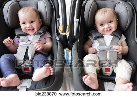 Caucasian twin baby girls in car seats View Large Photo Image Stock Image - Caucasian twin baby girls in car seats. Fotosearch