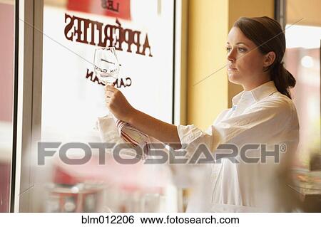 Caucasian waitress cleaning wine glass in restaurant View Large Photo Image Stock Photograph - Caucasian waitress cleaning wine glass in restaurant. Fotosearch