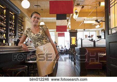 Caucasian waitress leaning on bar in restaurant View Large Photo Image Stock Photograph - Caucasian waitress leaning on bar in restaurant. Fotosearch