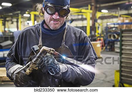 Caucasian welder adjusting blowtorch in factory View Large Photo Image Stock Image - Caucasian welder adjusting blowtorch in factory. Fotosearch