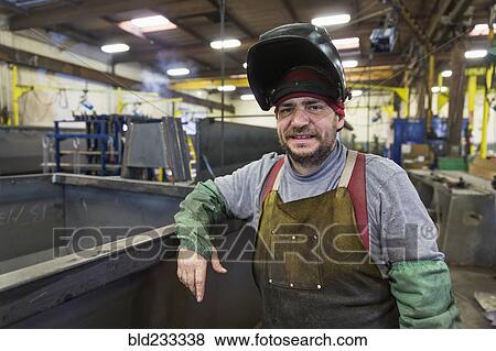 Caucasian welder posing in factory View Large Photo Image Stock Photo - Caucasian welder posing in factory. Fotosearch