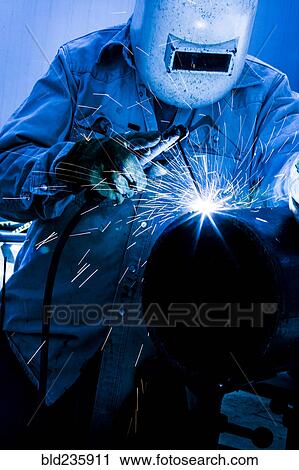 Caucasian welder working in factory View Large Photo Image Stock Image - Caucasian welder working in factory. Fotosearch