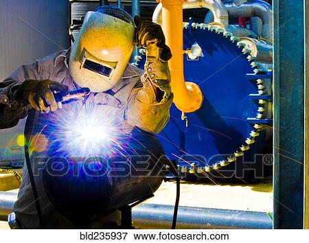 Caucasian welder working in factory View Large Photo Image Stock Photo - Caucasian welder working in factory. Fotosearch