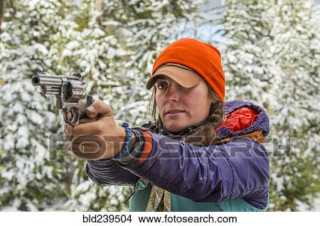 Caucasian woman aiming handgun in winter View Large Photo Image Picture - Caucasian woman aiming handgun in winter. Fotosearch