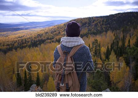 Caucasian woman backpacking in autumn landscape View Large Photo Image Stock Photo - Caucasian woman backpacking in autumn landscape. Fotosearch