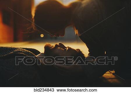 Caucasian woman caressing man laying on floor View Large Photo Image Stock Image - Caucasian woman caressing man laying on floor. Fotosearch