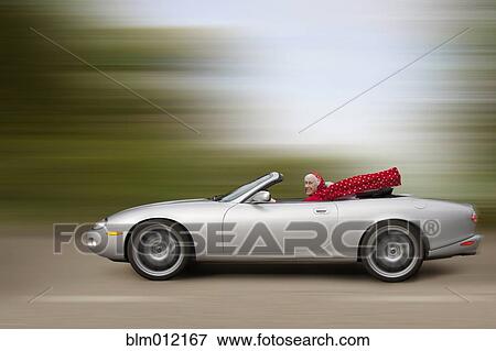Stock Photo - Caucasian woman driving car at high speed. Fotosearch