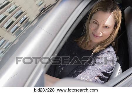 Stock Photo - Caucasian woman driving car. Fotosearch