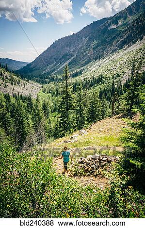 Caucasian woman hiking downhill on path in mountains View Large Photo Image Stock Photo - Caucasian woman hiking downhill on path in mountains. Fotosearch