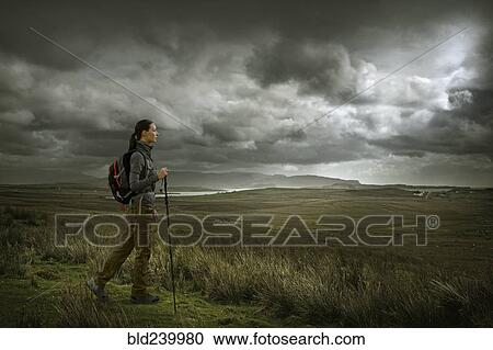 Caucasian woman hiking in green landscape View Large Photo Image Stock Image - Caucasian woman hiking in green landscape. Fotosearch