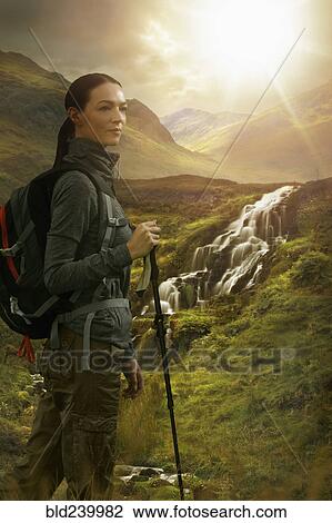 Caucasian woman hiking near waterfall View Large Photo Image Stock Image - Caucasian woman hiking near waterfall. Fotosearch