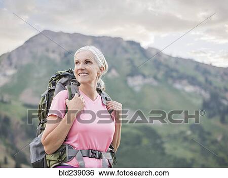 Caucasian woman hiking on mountain View Large Photo Image Stock Photograph - Caucasian woman hiking on mountain. Fotosearch