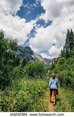 Caucasian woman hiking on path in mountains View Large Photo Image Picture - Caucasian woman hiking on path in mountains. Fotosearch