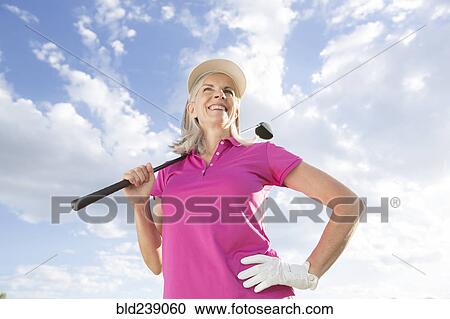 Caucasian woman holding golf club View Large Photo Image Stock Image - Caucasian woman holding golf club. Fotosearch