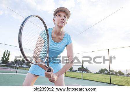 Caucasian woman holding tennis racket View Large Photo Image Stock Image - Caucasian woman holding tennis racket. Fotosearch