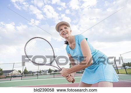 Caucasian woman holding tennis racket View Large Photo Image Stock Photo - Caucasian woman holding tennis racket. Fotosearch